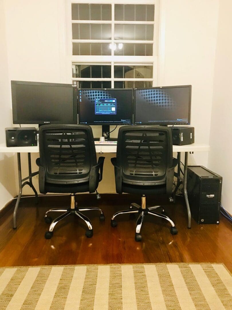 Two computer monitors are sitting on a desk.